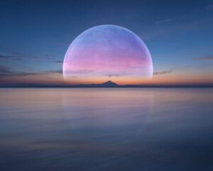 Big beautiful planet over the sea horizon rises at dawn