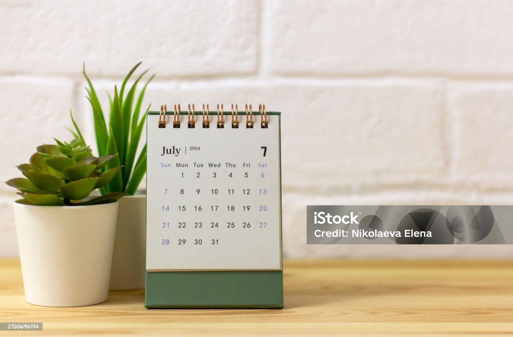 Desk calendar for July 2024 on the table with copy space